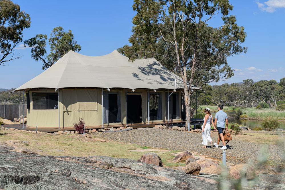 Luxury riverfront glamping tent in Stanthorpe for couples. Electric king bed, outdoor bath, fireplace and private deck overlooking the Severn River.